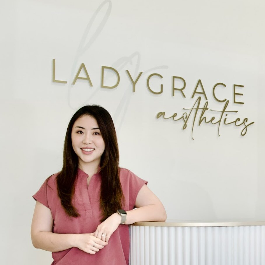LadyGrace Aesthetics clinic founder beneath the brand signage